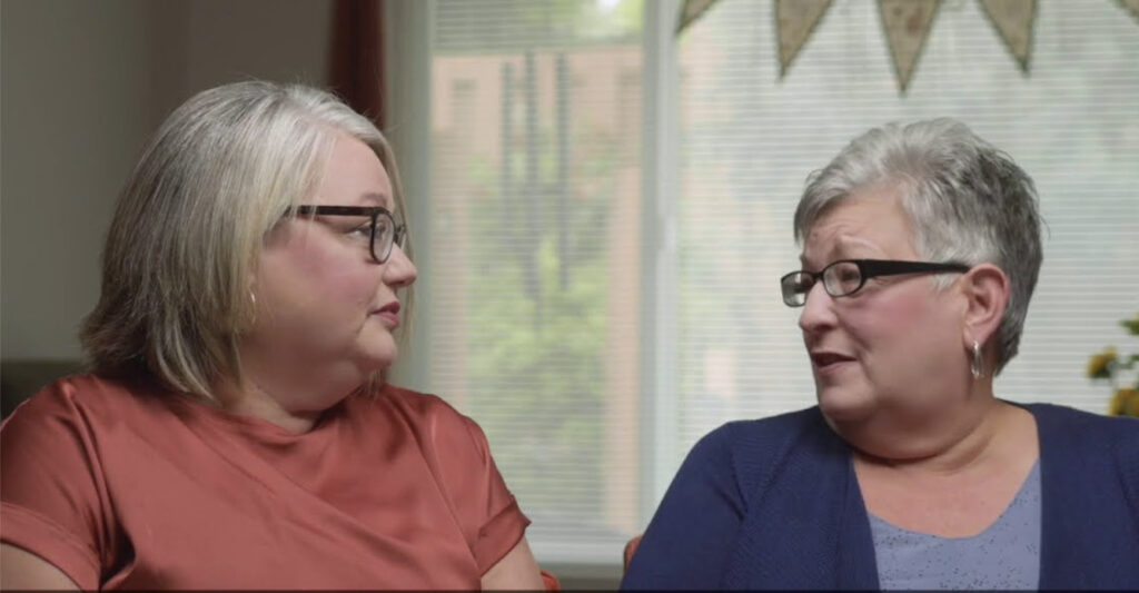 Mother and daughter conversing in mother's apartment at Charter Senior Living of Vinings