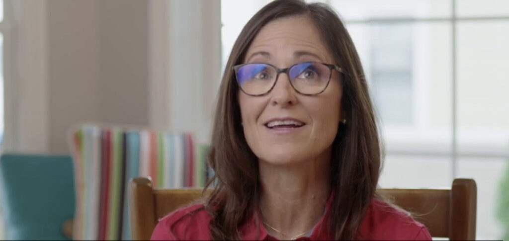 Smiling brunette woman giving an interview