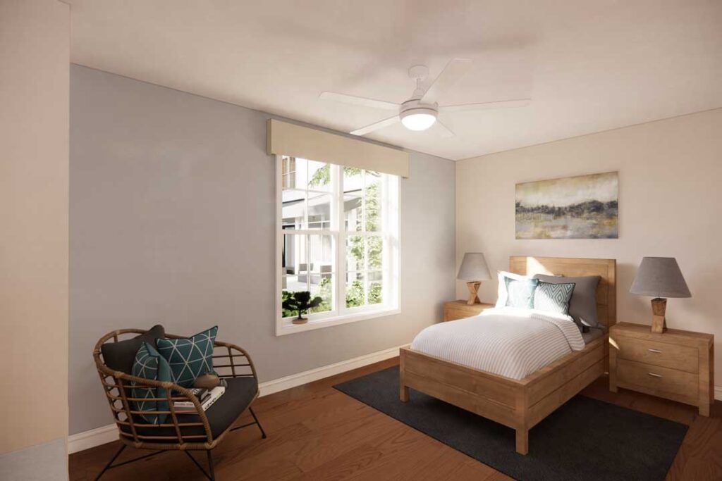 Bright bedroom with large window and cozy seating at Charter Senior Living of Vinings in Atlanta, GA.