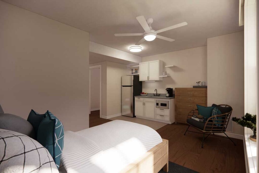 Comfortable senior suite with bed, kitchen, and modern furnishings at Charter Senior Living of Vinings in Atlanta, GA.