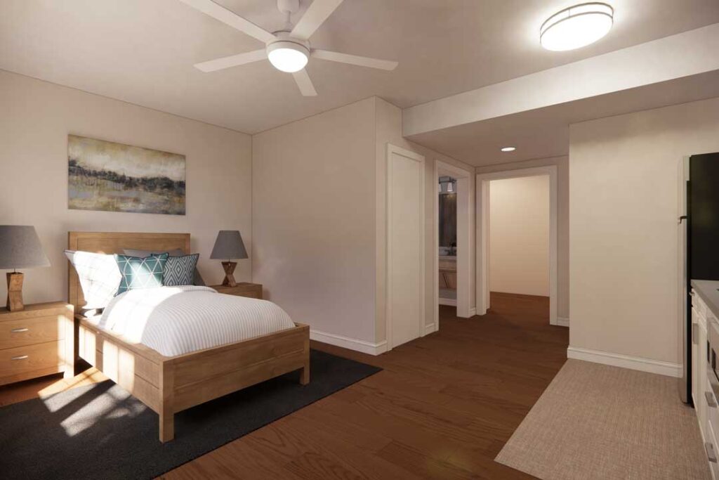 Modern senior apartment with bed, nightstands, and ceiling fan at Charter Senior Living of Vinings in Atlanta, GA.